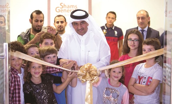 Dr Khalid K al-Hajri, chairman and CEO of QSTec, flanked by students inaugurates the solar art exhibition at Katara yesterday.