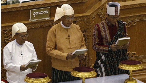 Myanmar's new president Htin Kyaw (C) first Vice President Myint Swe (L) and second Vice President Henry Van Thio swearing-in at union parliament in Naypyitaw. Reuters