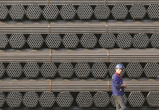 A worker walks past a pile of steel pipe products at the yard of the Youfa plant in Hebei province. The Brussels-based European Steel Association representing all steel production in the European Union, which is the second largest steel producer in the world after China, said the time had come for Europe to act against massive steel dumping by China.