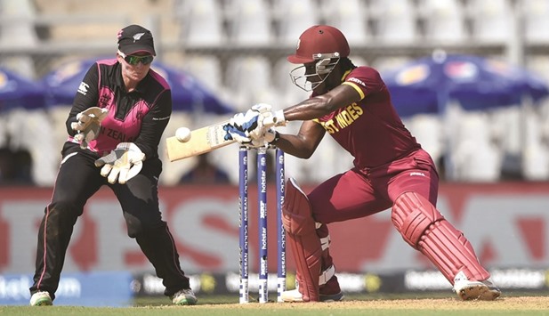 New Zealand wicketkeeper Rachel Priest (L) looks on as West Indies cricketer Britney Cooper plays a shot yesterday.