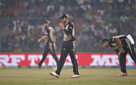 New Zealandu2019s captain Kane Williamson (C) walks on the field during the first semi-final against England.