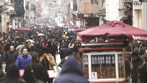 People walk on Istiklal Street on a rainy day in Istanbul. The economy grew 5.7% in the fourth quarter of 2015, the highest among the G20 group of nations after China and India, according to data compiled by Bloomberg.