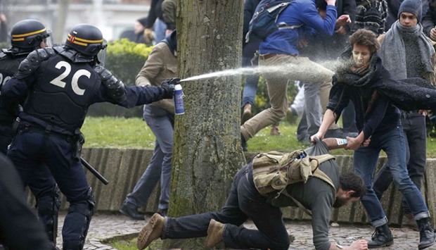 French gendarmes use tear gas during clashes with youths in Lille during a protest yesterday by employees, high school and university students against the French labour law reform proposal.
