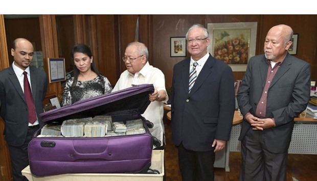 Anti-Money Laundering Council (AMLC) executive director Julia Abad (2nd L) with second secretary and chancery of the Bangladesh embassy Probash Lamarong (L), AMLC member and Insurance Commissioner Emmanuel Dooc (C), attorney Inocencio Ferrer, legal council of Kim Wong (2nd R) and Central Bank of the Philippines Deputy Governor Vicente Aquino at the physical counting and verification of the turned-over money at the Central Bank of the Philippines headquarters in Manila. Anti-Money Laundering Council (AMLC) executive director Julia Abad (2nd L) with second secretary and chancery of the Bangladesh embassy Probash Lamarong (L), AMLC member and Insurance Commissioner Emmanuel Dooc (C), attorney Inocencio Ferrer, legal council of Kim Wong (2nd R) and Central Bank of the Philippines Deputy Governor Vicente Aquino at the physical counting and verification of the turned-over money at the Central Bank of the Philippines headquarters in Manila.