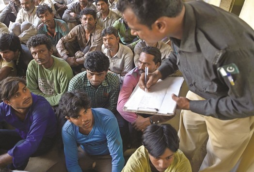 A Pakistani policeman records information from arrested Indian fishermen at a police station in Karachi yesterday. Pakistanu2019s Maritime Security Agency has arrested 59 Indian fishermen and seized ten boats for allegedly fishing illegally in Pakistani waters.