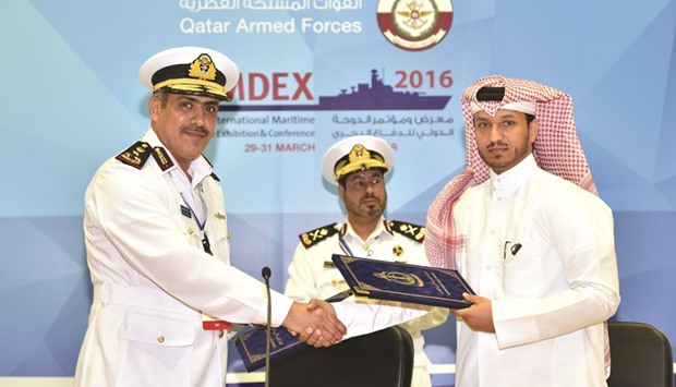 Top officials of Qatar Emiri Naval Forces and Qatari company Nakilat shaking hands after signing a MoU yesterday at Dimdex 2016.
