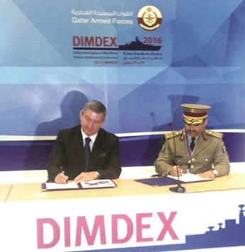 Betrand Deyzac of Airbus Defence and Space and Brigadier al-Dosari (right) signing the agreement.