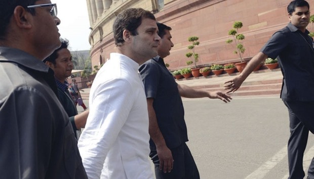 Congress vice president Rahul Gandhi is escorted by security officers as he arrives at the parliament yesterday.