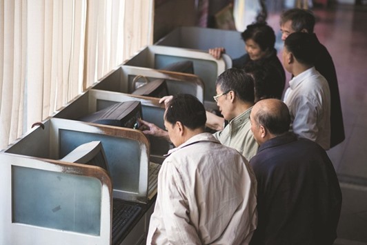 Investors follow financial information at a securities brokerage in Shanghai. Chinau2019s stock market has become one of the most visible symbols of anxiety towards Asiau2019s largest economy after a $5tn crash last summer rattled global investors.