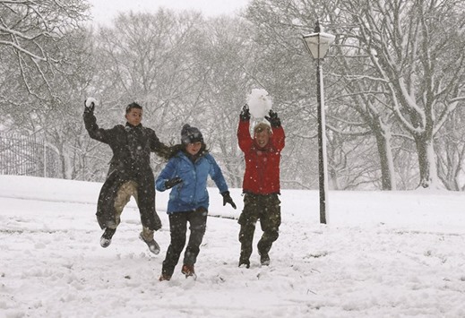 Students have a snowball fight during snowfall in Buxton yesterday. Heavy snowfall has caused u201cchaosu201d in parts of northern England, with forecasters predicting further cold weather in the days to come. Yorkshire and Lancashire have been worst affected, after 2cm-5cm fell overnight, with 10cm reported on higher ground. More than 100 schools have been closed across East Lancashire and Oldham.