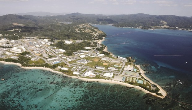 Coral reefs are seen along the coast near the US Marine base Camp Schwab, off the tiny hamlet of Henoko in Nago, on the southern Japanese island of Okinawa, in this file aerial photo taken by Kyodo on October 29, 2015. Japanese Prime Minister Shinzo Abe said yesterday that the government would accept a court-mediated settlement plan and suspend construction work for the planned relocation of a US airbase in the southern island of Okinawa.