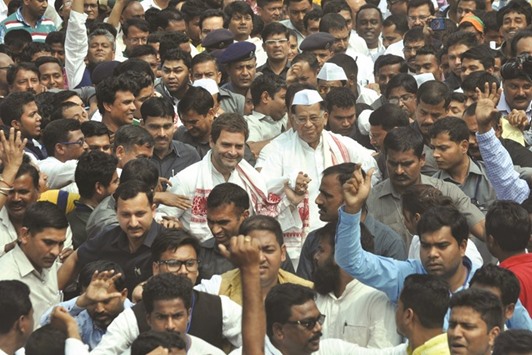 Congress vice president Rahul Gandhi and Assam Chief Minister Tarun Gogoi are seen with party supporters during an election campaign rally in Nagaon near Guwahati yesterday.