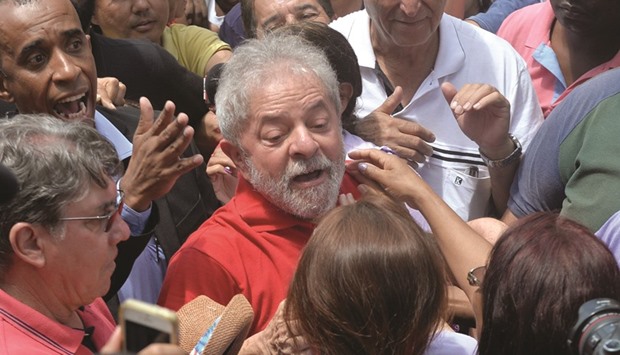Former Brazilian president Luiz Inacio Lula da Silva meets supporters gathering outside his house to show him their support, in Sao Bernardo do Campo, near Sao Paulo, Brazil yesterday.