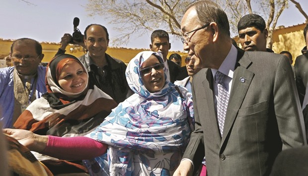 UN Secretary General Ban Ki-moon listens to a member of the Sahrawi womenu2019s national union after his press conference at the Sahrawi Arab Democratic Republic presidential palace in Tindouf, southern Algeria.