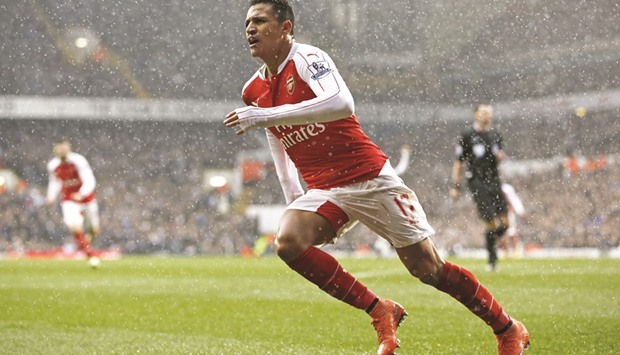 Alexis Sanchez celebrates after scoring the equaliser for Arsenal in their crucial north London derby against title challengers Tottenham Hotspur, in the Premier League yesterday. (Reuters)