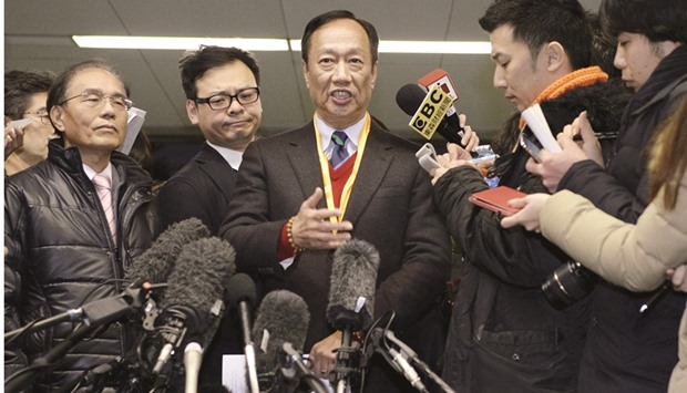 Terry Gou (centre), founder and chairman of Taiwanu2019s Foxconn, speaks to reporters after a meeting with Sharp executives in Osaka (file). The Japanese firm faces the expiration of u00a5510bn in credit lines and loans on March 31.