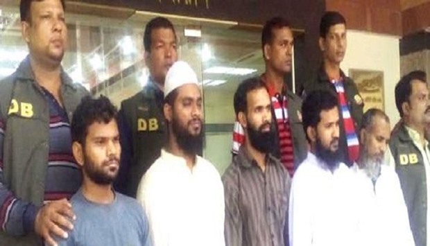 Police with the arrested members of Jamaat-ul-Mujahideen Bangladesh for their alleged involvement  in attacking police at Ashulia and Gabtali check-posts and bomb blast at Hussaini Dalan in Dhaka. 2015 November 26 file picture.