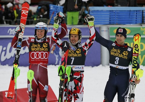 Henrik Kristoffersen of Norway, Marcel Hirscher of Austria and Stefano Gross of Italy (L-R) react on the podium after their race yesterday.