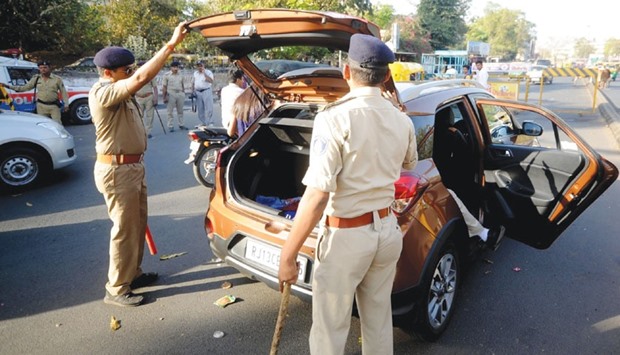 Police check a car in Ahmedabad after the government sounded a high alert amid reports that 10 militants have entered Gujarat, yesterday.
