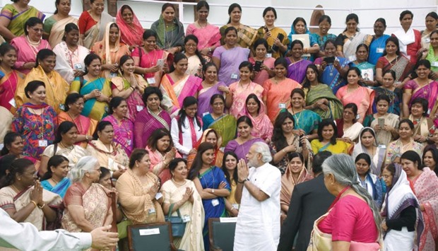 Prime Minister Narendra Modi greets women legislators at the Central Hall of Parliament in New Delhi yesterday.