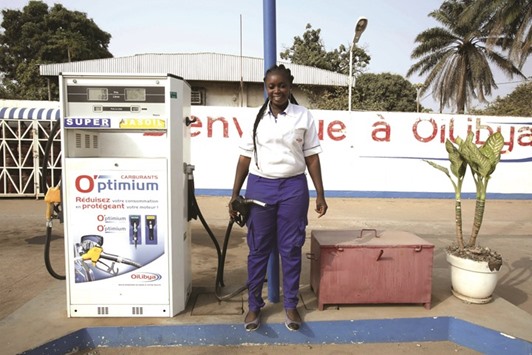 Natenin Konate, a 22-year-old gas station attendant, poses for a photograph in Bouake, Ivory Coast. Women have long played a dominant role in agriculture in Ivory Coast and in the sprawling markets where most Ivorians purchase their daily necessities. Now some are breaking through into the most important positions in government, administration and business.