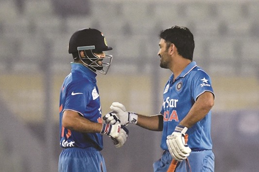 File picture of Indiau2019s captain Mahendra Singh Dhoni (R) shaking hands with Virat Kohli after winning their match against Sri Lankan during the Asia Cup T20 tournament.