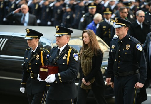 The ashes of former NYPD officer David Hofer, a graduate of NYU who served in Manhattanu2019s Ninth Precinct for five years, are carried into Saint Patricku2019s Cathedral by officers of the Euless, Texas police department in New York.  Hofer,who became a police officer in Texas, to escape the streets in New York, was killed in a shootout last week in Euless. Behind them is his fiance Marta Danylyk.