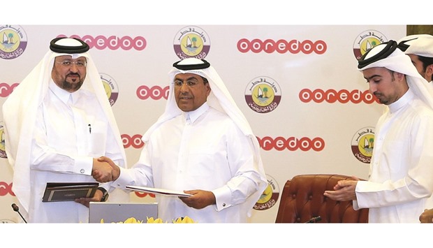 Ministry of Foreign Affairs and Ooredoo officials after signing the new agreement yesterday.