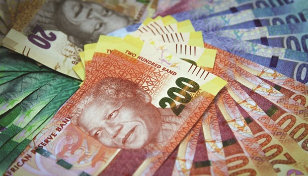 Mixed denomination rand currency banknotes are arranged for a photograph in Johannesburg. A sinking rand has sparked a buying spree and rerating of South African gold mining shares which have doubled in value in 2016, but the volatile currency is a double-edged sword that could cut the gains back down to size.