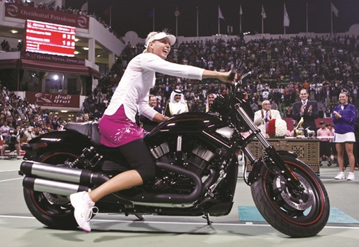 Maria Sharapova celebrates on a bike after winning the WTA Qatar Open title in Doha in this file photo dated February 24, 2008. (Reuters)