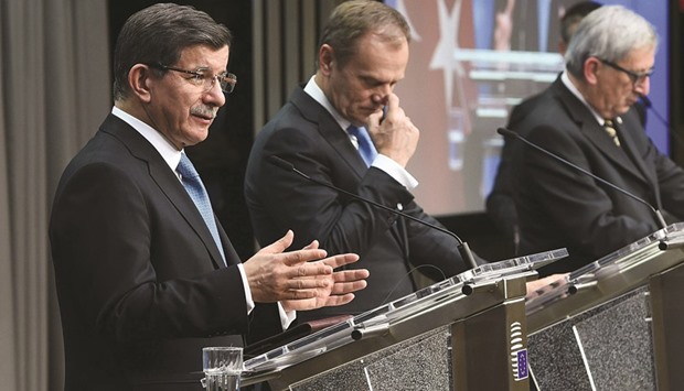 Turkeyu2019s Prime Minister Ahmet Davutoglu (left), European Council President Donald Tusk (centre) and European Commission President Jean-Claude Juncker speak during a press conference at the end of an EU leaders summit with Turkey centred on the migrants crisis, at the European Council, in Brussels yesterday.