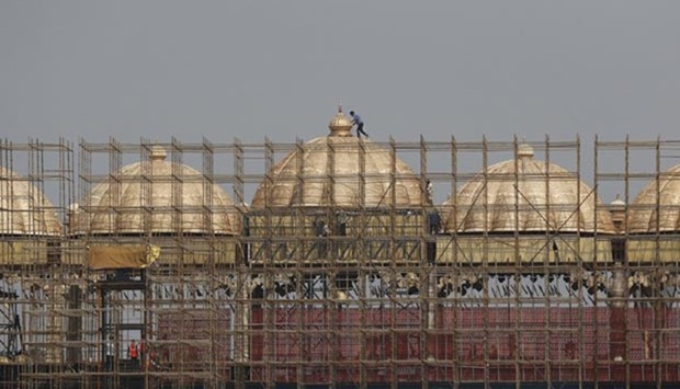 Workers erect scaffolding to build a stage at the venue of World Culture Festival on the banks of the river Yamuna in New Delhi.