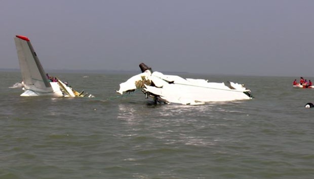 Bangladesh rescuers gather around the wreckage of a cargo plane that crashed into the sea off Cox's Bazar on Wednesday.