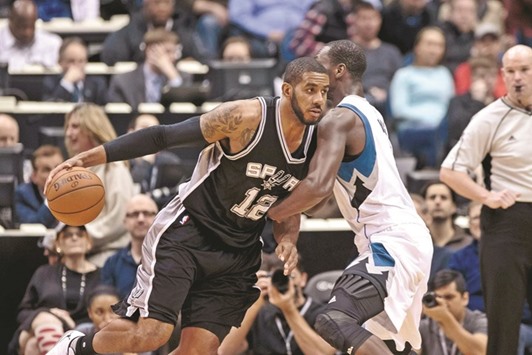 San Antonio Spurs forward LaMarcus Aldridge (left) dribbles past Minnesota Timberwolves center Gorgui Dieng in the first quarter at Target Center in Minneapolis, on Tuesday. (USA TODAY Sports)