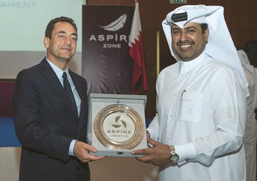 Aspire Logistics director general Abdullah al-Naimi (right) presents a memento to French ambassador to Qatar Eric Chevallier.