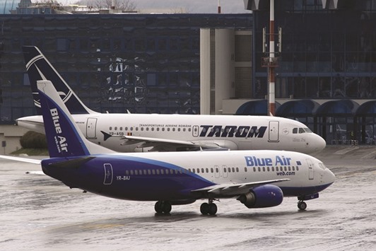 A Blue Air Airlines Boeing 737 and a Tarom Airlines Airbus A318 are seen at Henri Coanda Airport in Otopeni, near Bucharest (file). A special meeting has been called for April in Montreal for policy makers from about a dozen countries to confer on a plan, which would achieve carbon-neutral growth in the aviation sector from 2020 onwards.