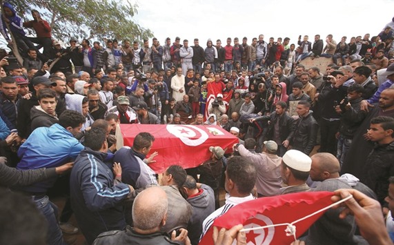 Mourners gather around a coffin of a person killed during Mondayu2019s attack on army and police posts in Ben Guerdan, Tunisia.