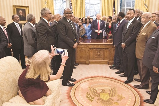Conway takes a photo as Trump and leaders of historically black universities and colleges talk before a group photo in the Oval Office, before a meeting with Vice-President Mike Pence.