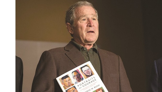 Bush with a copy of his Portraits of Courage painting exhibit.