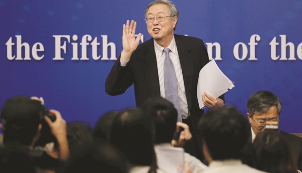 Governor of the Peopleu2019s Bank of China Zhou Xiaochuan at a press conference during the Fifth Session of the 12th National Peopleu2019s Congress in Beijing yesterday. Zhou said efforts will be made to contain Chinau2019s debt levels, including restructuring of firms with heavy debt burdens, alongside a push to reduce excess industrial capacity.