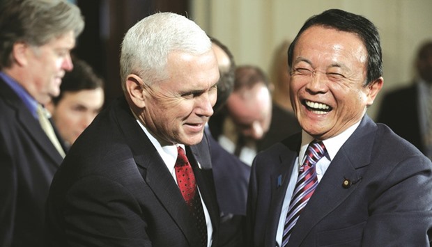 US Vice President Mike Pence (left) speaks with Japanese Finance Minister Taro Aso in Washington. Japan rejected US demands for more access to Japanu2019s car market yesterday, casting doubt over whether it can avoid friction over autos and agriculture imports at high level bilateral talks on economic relations in April.