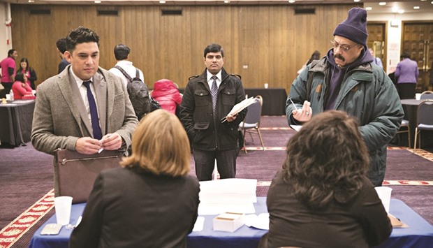 Candidates speak to recruiters during a job fair in Chicago (file). Nonfarm payrolls increased by 235,000 jobs last month as the construction sector recorded its largest gain in nearly 10 years due to unseasonably warm weather, the Labour Department said yesterday.