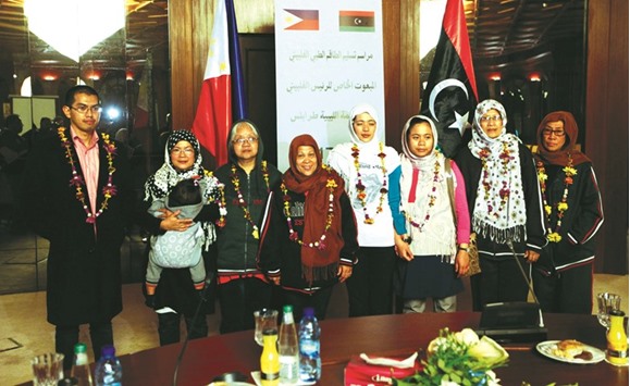 Filipino nurses, who were freed from Islamic State militants by Libyan forces in Sirte, pose for a group photo during a handover ceremony in the presence of a Filipino envoy in Tripoli, Libya.