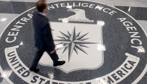 a man walking over the seal of the Central Intelligence Agency (CIA)