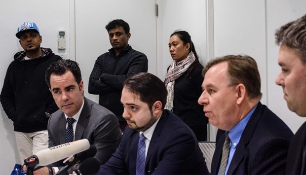 Lawyer Robert Tibbo (2nd R) and his Montreal based Canadian counterparts Francis Tourigny (L), Marc-Andre Seguin, (2nd L) and Michael Simkin (R), speak during a press conference with the refugee clients (back), who helped shelter fugitive whistleblower Edward Snowden in 2013