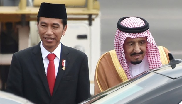 Indonesia's President Joko Widodo (L) welcomes Saudi Arabia's King Salman bin Abdul Aziz