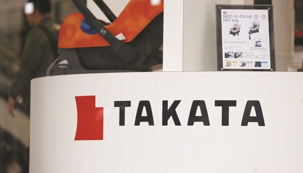 The logo of Takata is seen at a showroom for vehicles in Tokyo. Nissan, BMW of North America and Ford Motor claim the embattled Tokyo-based company withheld information about the inflators, which have caused airbags to rupture and injure people.