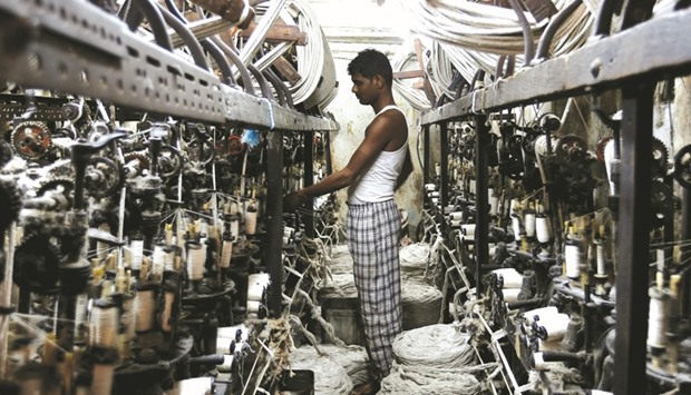 An employee works inside a garment factory in Mumbai. Indiau2019s factory output, as per the Index of Industrial Production (IIP), had inched lower by 0.10% during December 2016.