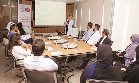 Al Khaliji employees attend a session of the u2018Together for a healthier youu2019 initiative.