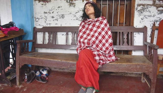 Irom Sharmila appears pensive as she sits on a bench in her house after losing her battle against three-time Manipur Chief Minister Ibobi Singh, in Imphal yesterday.